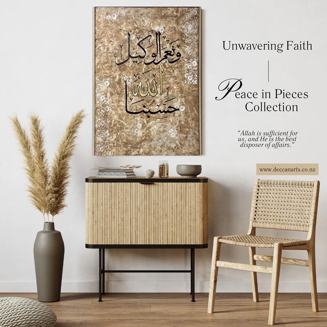 A modern room with a rattan chair and console table features a framed Islamic calligraphy art titled Unweavering Faith from the Peace in Pieces Collection, displaying a quote about trust in Allah.